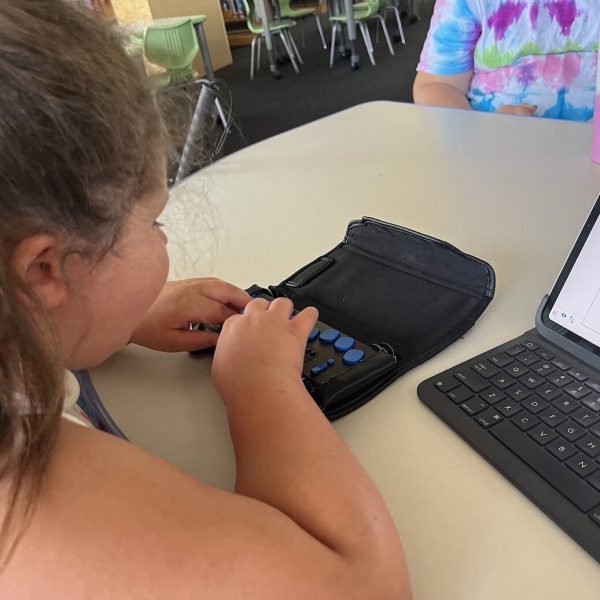 student sits at a desk typing on a Focus 40 connected to an iPad